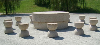 This stone carved table with 12 stools